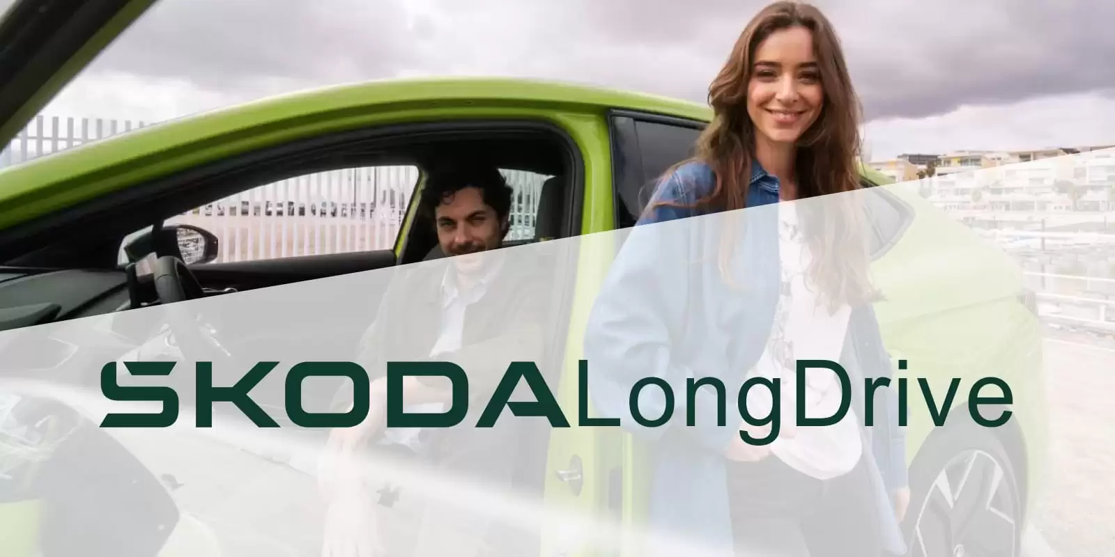 Una pareja en un coche con el logo de ŠKODA LongDrive 